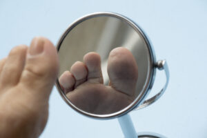 vecteezy person looking at the sole of the foot in a mirror to check 12573412